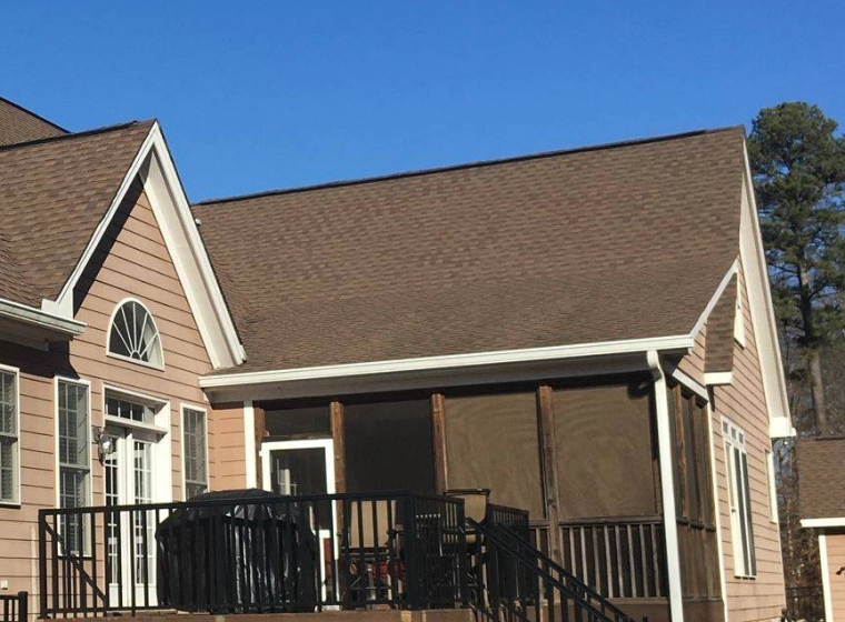 brown house with trimmed pine roofing holly springs nc